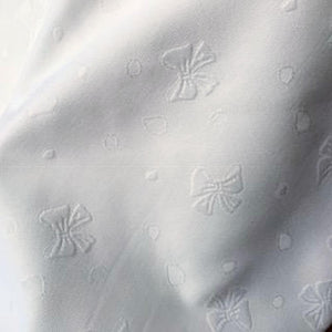 Swiss Pique - 100% Swiss Cotton - 150cm Wide. Code F#7 - Bows design. White only.